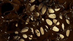 Super Slow Motion of Falling Blanched Almonds Into Melted Chocolate. Filmed on High Speed Cinema Camera, 1000fps. - Powered by Shutterstock - Get 15% off with code: PIKWIZARD15