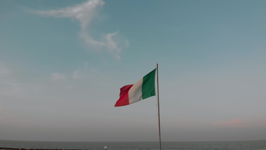 Italy flag. National Italian flag waving from wind on the background of a beautiful sky at sunset. Flagpole. Dusk. Video for presentation Rome, Colosseum, Milan, Venice - Powered by Shutterstock - Get 15% off with code: PIKWIZARD15