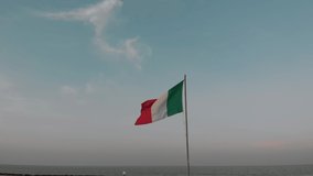 Italy flag. National Italian flag waving from wind on the background of a beautiful sky at sunset. Flagpole. Dusk. Video for presentation Rome, Colosseum, Milan, Venice - Powered by Shutterstock - Get 15% off with code: PIKWIZARD15