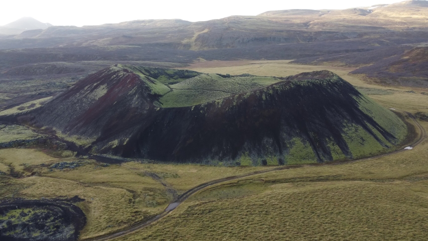 Fast flight over green volcanic crater