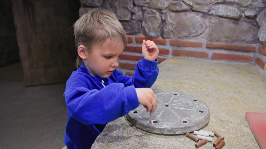 kids intellectual development, cute male child playing with the museum archeology simulator