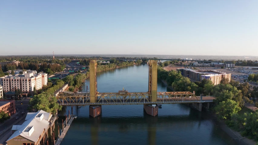 Aerial panning shot of Tower Bridge that spans across the Sacramento River. 4K