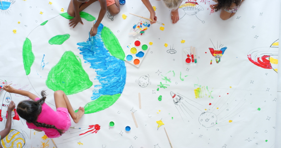 Painting, drawing and art activity for children during elementary school lesson for Eath day project from above. Diverse kids being creative and having fun while learning about the globe and geology Royalty-Free Stock Footage #1092695393