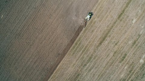 Aerial view plowing the land by tractor for cultivation. Kyiv region, Ukraine