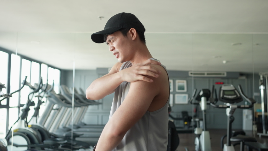 slow motion scene young man use hand to massage on shoulder to relieve symptom of pain after workout for health care people and lifestyle concept Royalty-Free Stock Footage #1092697987