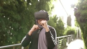 arab muslim woman using virtual reality sport, boxing simulator