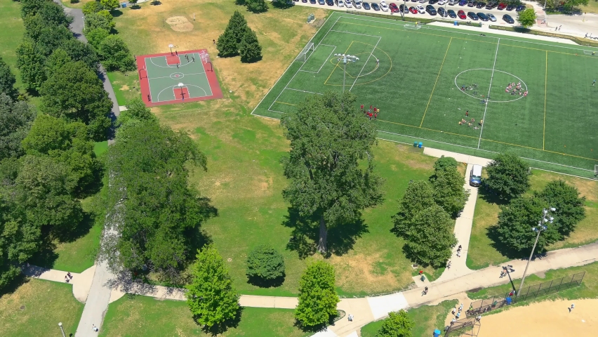 Aerial fly over shot of basketball courts, and soccer field at North Avenue beach | Chicago Illinois | Afternoon lighting