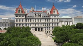 New York State capitol building in Albany, New York with drone video close up moving up with trees.