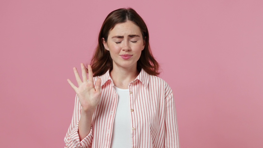 Young caucasian woman 20s she wear shirt t-shirt look camera pointing fingers herself ask say who me no thanks i do not need it isolated on plain pastel light pink background. People lifestyle concept | Shutterstock HD Video #1092722227
