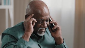 Old bald African businessman with gray beard aged male client thinks speaking on the phone remembers remote consultation loses forgets memory problems business troubles failure headache pain stress - Powered by Shutterstock - Get 15% off with code: PIKWIZARD15