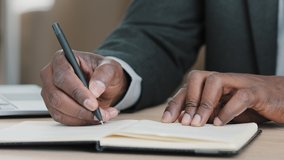 African old senior male hands unrecognizable businessman in formal suit holding pen writing new appointments information in organizer making notes in personal paper planner at desk write in notebook - Powered by Shutterstock - Get 15% off with code: PIKWIZARD15
