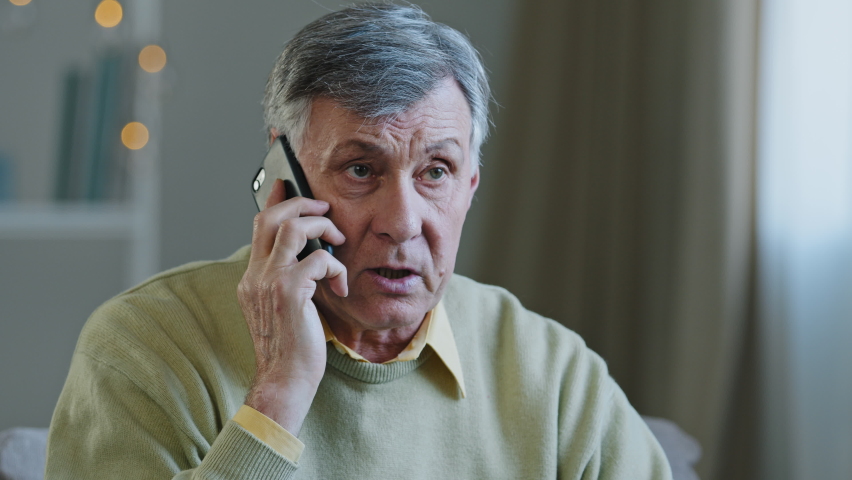Stressed old man worried Caucasian senior mature grandfather hearing awful news at mobile phone call conversation unhappy sad male talking on smartphone having business failure health problem Royalty-Free Stock Footage #1092722385