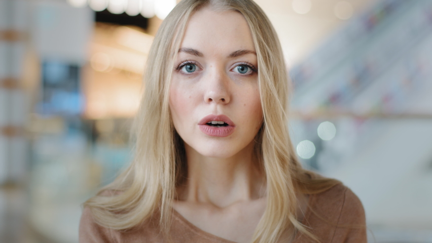 Close-up female face indoors portrait blond 20s girl millennial woman lady confused female looking at camera with interest searching someone listening attentively waiting puzzled expression emotions Royalty-Free Stock Footage #1092722399