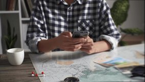 Girl traveler tourist sits on the background of the map looking for beautiful places on the Internet using a smartphone, a tourist uses the phone to find a route for hiking
 - Powered by Shutterstock - Get 15% off with code: PIKWIZARD15