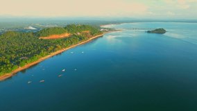 A drone is flying over the coast during sunrise in Chumphon, Thailand. Tropical sea. 4k.
