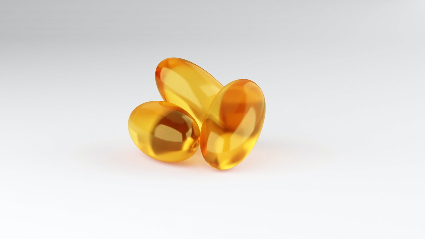 Soft gelatin capsules for containing oily drugs and nutritional supplements like vitamin A, and E. 3D rendering motion. Falling Omega-3 fish oil liquid gel capsules falling over white background