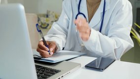 Closeup of doctor or nurse woman in uniform with stethoscope writing information of patient prescription in paperwork on clipboard and typing laptop computer for history record medical document report - Powered by Shutterstock - Get 15% off with code: PIKWIZARD15