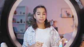 Black teen girl recording video for her beauty blog, makeup tutorial, pov