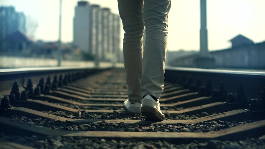 Lonely Businessman Feet In Pants Walking On Rail Road When Train Or Tram Cancelled. Man Walks To Home On Railroad Tracks After Canceled Public Transport .Tourist Legs Walking On Railway Middle Of Rail