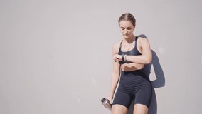 Cinematic action footage of a sport woman training and doing fitness exercises outdoor in an urban area of the city. Concept about running and active workouts