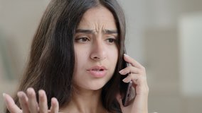 Annoyed arabian angry teenage girl furious emotional woman talk smartphone has quarrel by mobile phone answers call misunderstanding quarrel conflict dissatisfied with service delivery bad - Powered by Shutterstock - Get 15% off with code: PIKWIZARD15