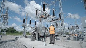 Construction of a transformer substation. Electrical engineer control wiring electric power on steel tower, Electric construction and maintenance services throughout, Electric Power - Powered by Shutterstock - Get 15% off with code: PIKWIZARD15
