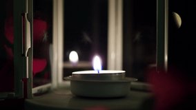 A candle burning at night in a decorative candlestick with flowers. Decorative floating candle burning in the dark with focus on one candle in the foreground. The concept of romance. - Powered by Shutterstock - Get 15% off with code: PIKWIZARD15