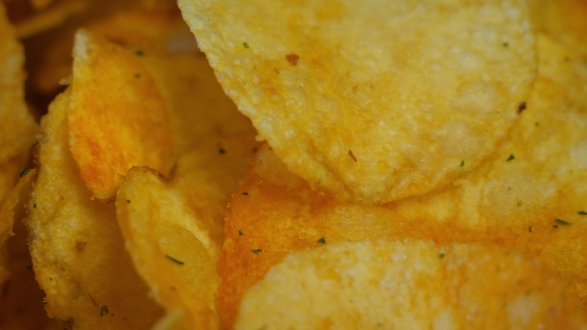 Background of Potato chips rotating close up. Top view, copy space.
