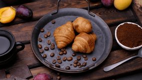 Croissants and coffee on a plate. Close-up 4k video shooting, light background