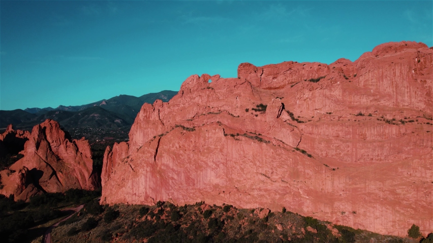 Garden of the Gods Colorado Drone View 9 4K features a view from a drone flying up a large rock formation to reveal the scenery behind in the Garden of the Gods, Colorado.