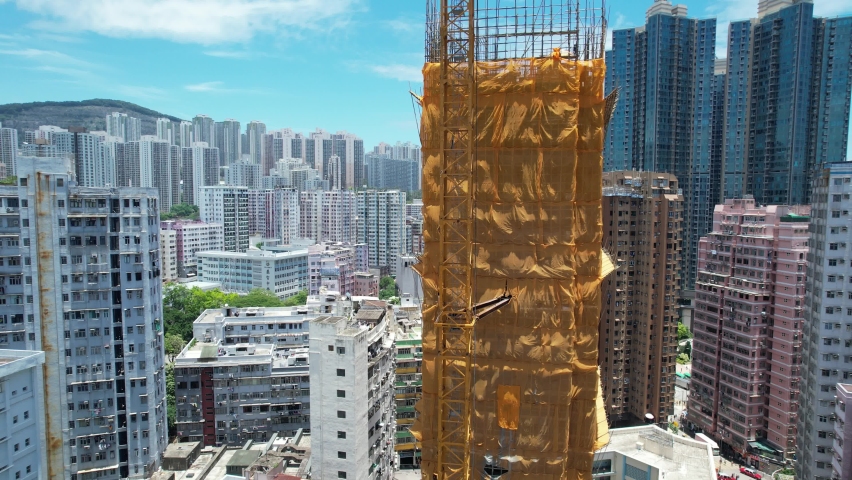 Commercial and residential construction development project in Kwun Tong of Hong Kong city, becoming the newest business district near Kowloon Bay and Victoria harbor, Aerial drone skyview | Shutterstock HD Video #1092786969