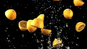 Pieces of juicy lemons with splashes of water fly up and fall down. On a black background. Filmed is slow motion 1000 fps. - Powered by Shutterstock - Get 15% off with code: PIKWIZARD15