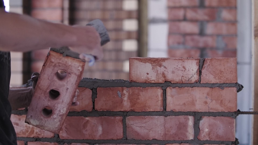 laying bricks in the house, builder hand Royalty-Free Stock Footage #1092799309