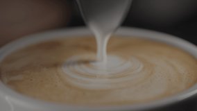 Slow motion pour steamed milk into espresso in white cup closeup - Powered by Shutterstock - Get 15% off with code: PIKWIZARD15