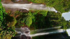 Beautiful waterfall hidden in tropical rainforest jungle on nature background 4K vertical video - Powered by Shutterstock - Get 15% off with code: PIKWIZARD15
