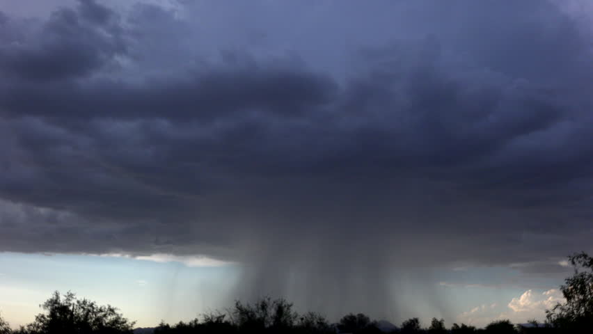 Time Lapse, Dark, monstrous mushroom cloud emits thick, sweeping wall of rain on mountain landscape. 4K UHD 3840x2160