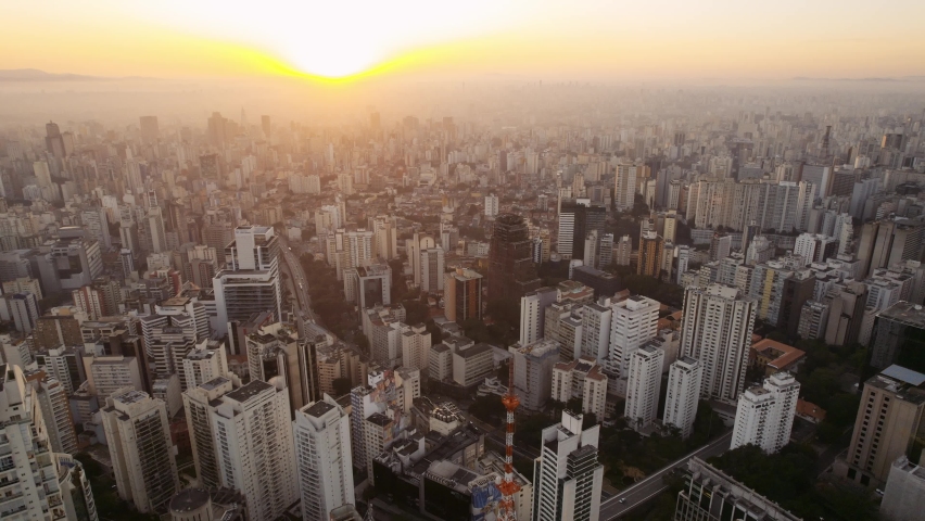 Aerial view of the São Paulo skyline at sunset, golden light over South America