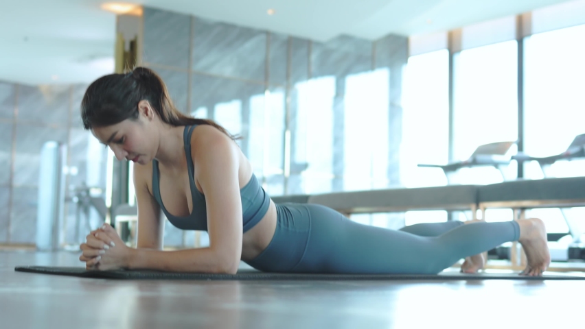 Asian Woman Wearing Sportswear doing planking exercise at sports club. Royalty-Free Stock Footage #1092807687