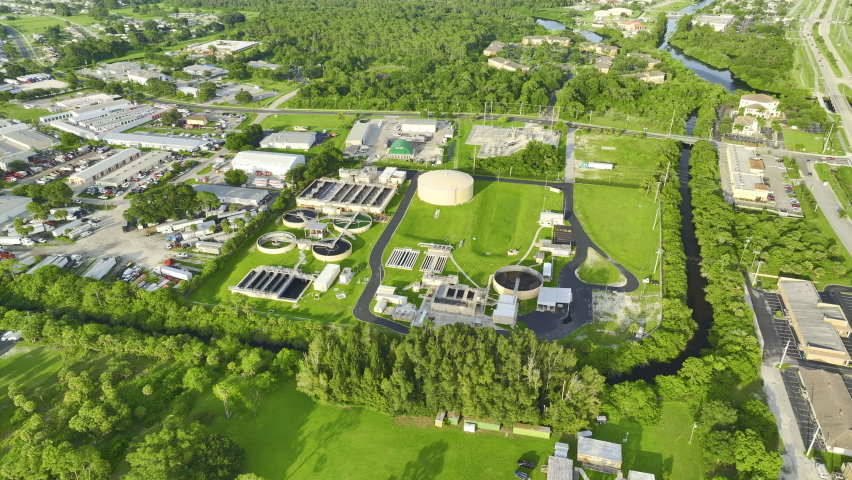 Aerial view of modern water cleaning facility at urban wastewater treatment plant. Purification process of removing undesirable chemicals, suspended solids and gases from contaminated liquid Royalty-Free Stock Footage #1092809813