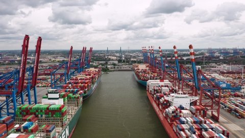 Hamburg, Germany - July 2022: Aerial view on the cranes and loaded cargo ships in Burchardkai Container Terminal (CTB) in the Port of Hamburg (Hamburger Hafen)