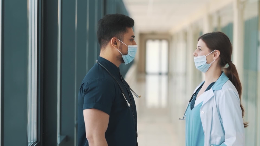 A doctor and a nurse are talking in a hospital corridor | Shutterstock HD Video #1092818273
