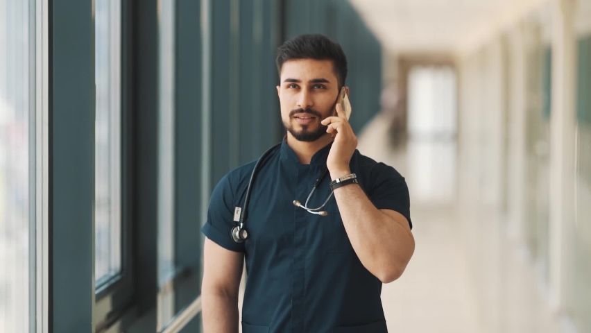 The intern doctor is talking on the phone in the corridor | Shutterstock HD Video #1092818289