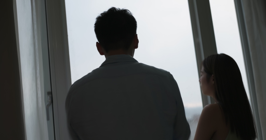silhoutte of asian couple has a serious argue in front of the window at home Royalty-Free Stock Footage #1092821693