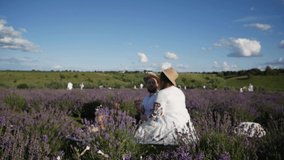 Man and woman hold glasses with white wine on background of a lavender field. Romantic picnic in sunset.  - Powered by Shutterstock - Get 15% off with code: PIKWIZARD15