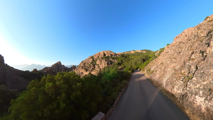 Aerial drone view of the Piana Badlands of Corsica on the D81 route at sunset. Les Calanques of Piana natural park in Mediterranean sea by the Porto Ota town. 360 view of UNESCO heritage Royalty-Free Stock Footage #1092826193