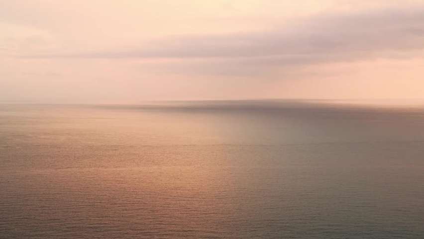 Aerial Drone View of Calming Peaceful Orange Ocean Seascape Background of Vast Sea and Sunset Clouds over Horizon with Copy Space, Calm Still Water | Shutterstock HD Video #1092828875