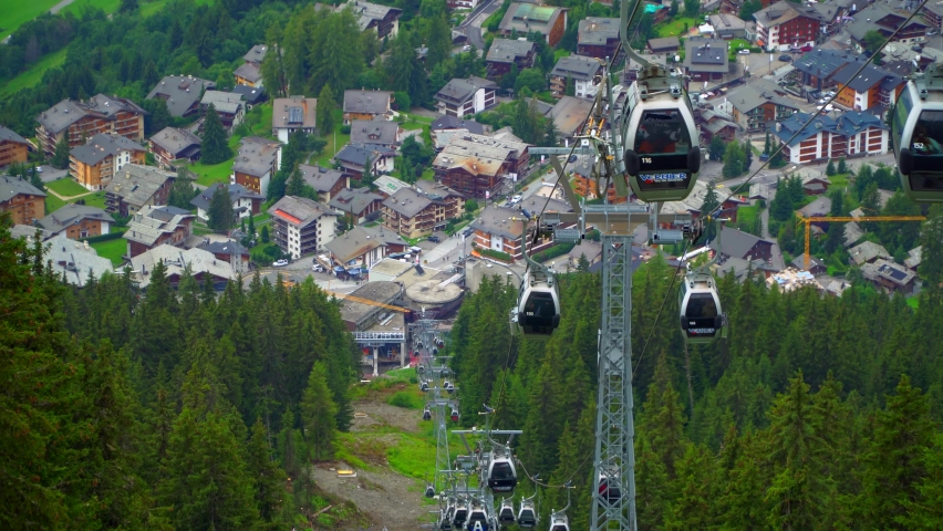 cableway cabins of the Swiss Alps in summer. Lift in the summer in the mountains. Sunny day and blue clear sky