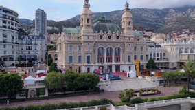 Aerial view of the old casino. area with palm trees. Luxurious super cars in front of the hotel. Monument and fountain. Modern architecture of the kingdom of MONTE CARLO, MONACO 07.2022