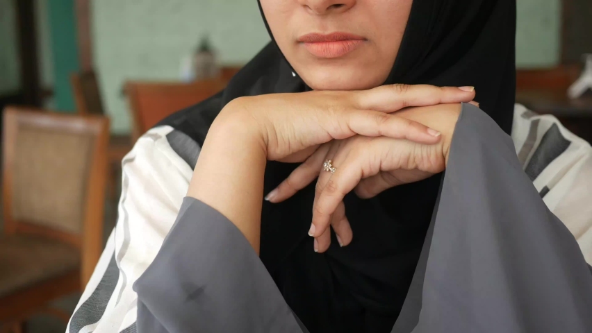 a thoughtful young women sitting on a chair 