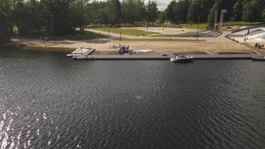 Aluksne lake shore with boat dock and playground